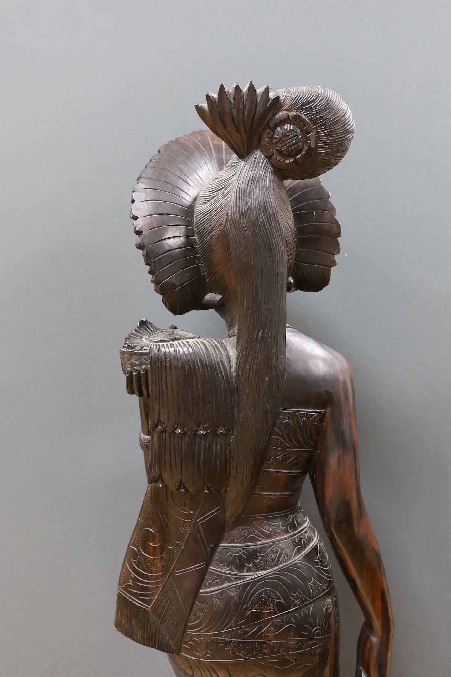 An unusually large and well-carved Balinese ebony figure of a standing young girl, early/mid 20th century. From a Bournemouth estate, 105cm high